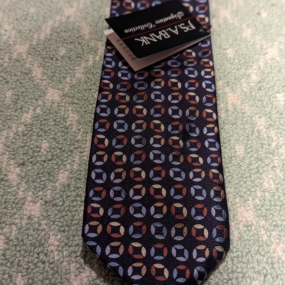 Jos. A. Bank signature collection navy tie with multi color geometric pattern.